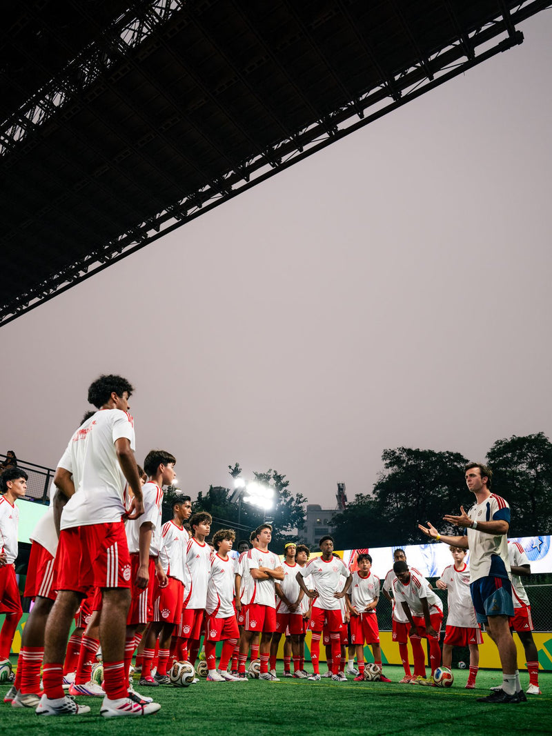 Team lined up under a bridge before a session