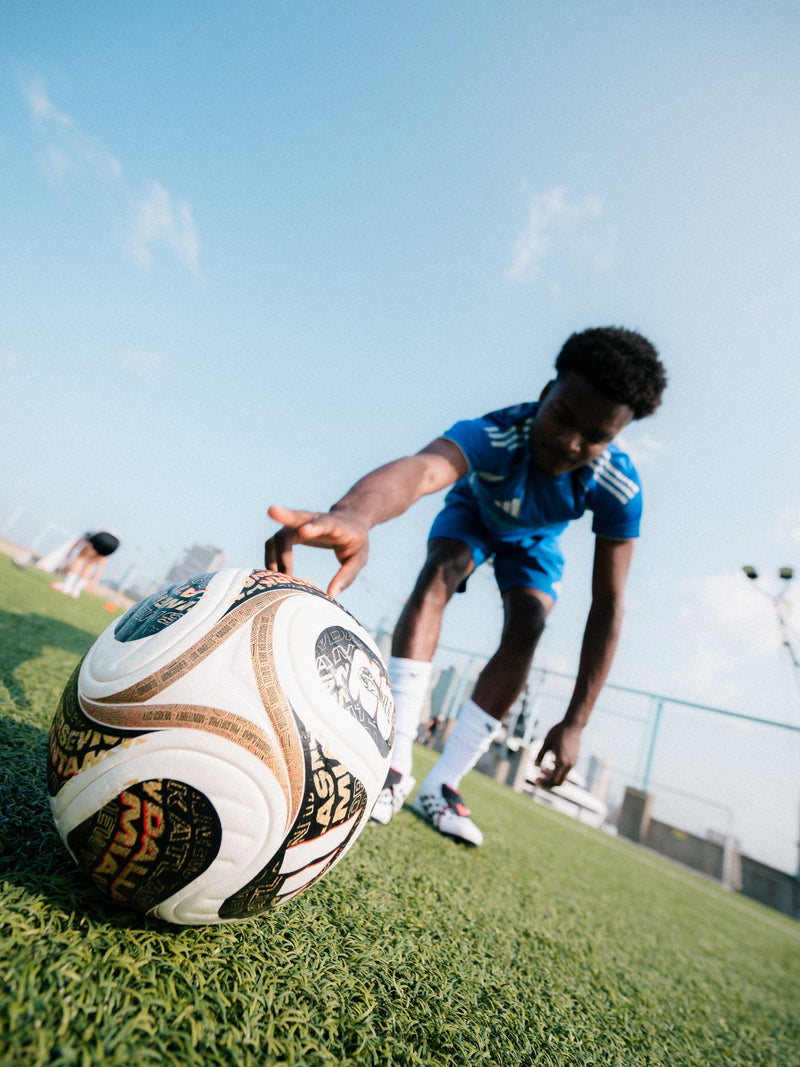 Low-angle frame of a player behind an oversized football