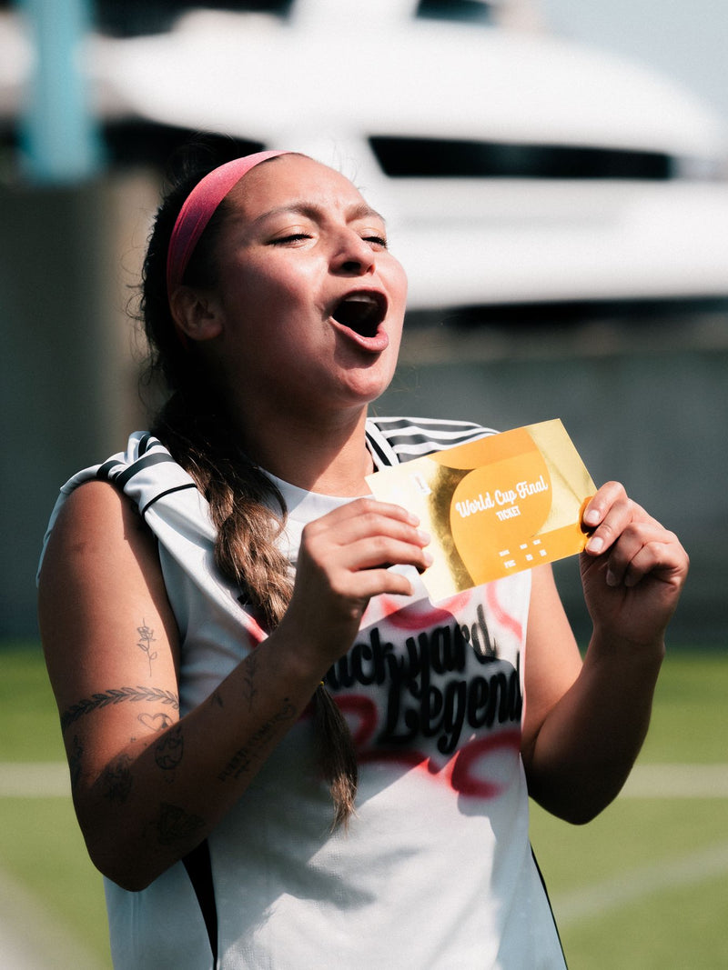 Participant holding a gold card, shouting