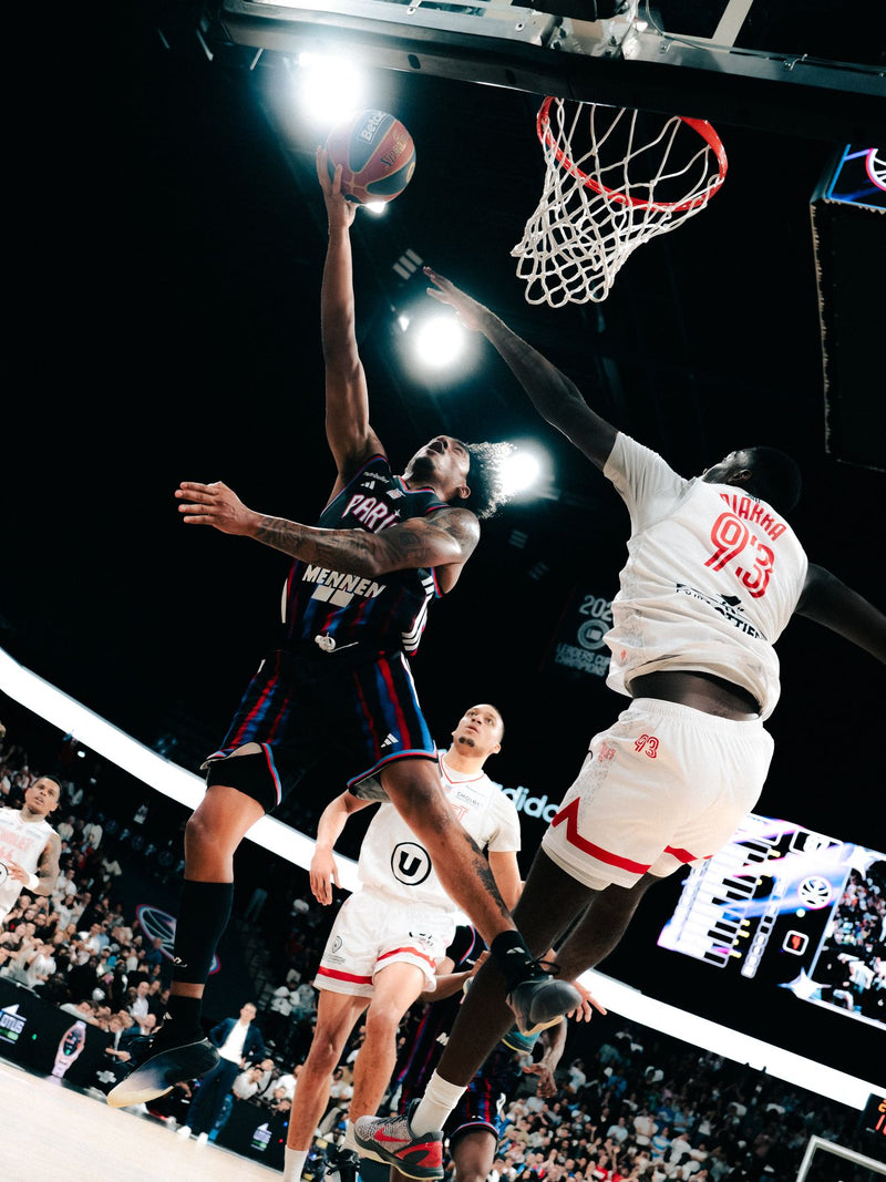 Layup at the rim in a packed indoor arena
