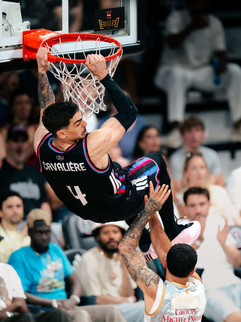 Player hanging from the rim after a dunk