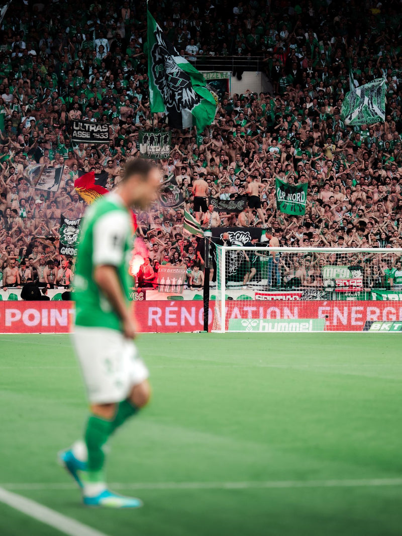 Player walking in front of a stand filled with green flags