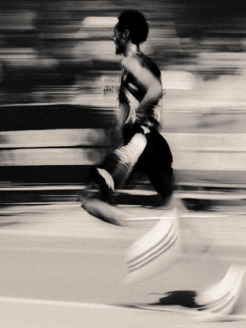 Motion-blurred runner striding across the frame