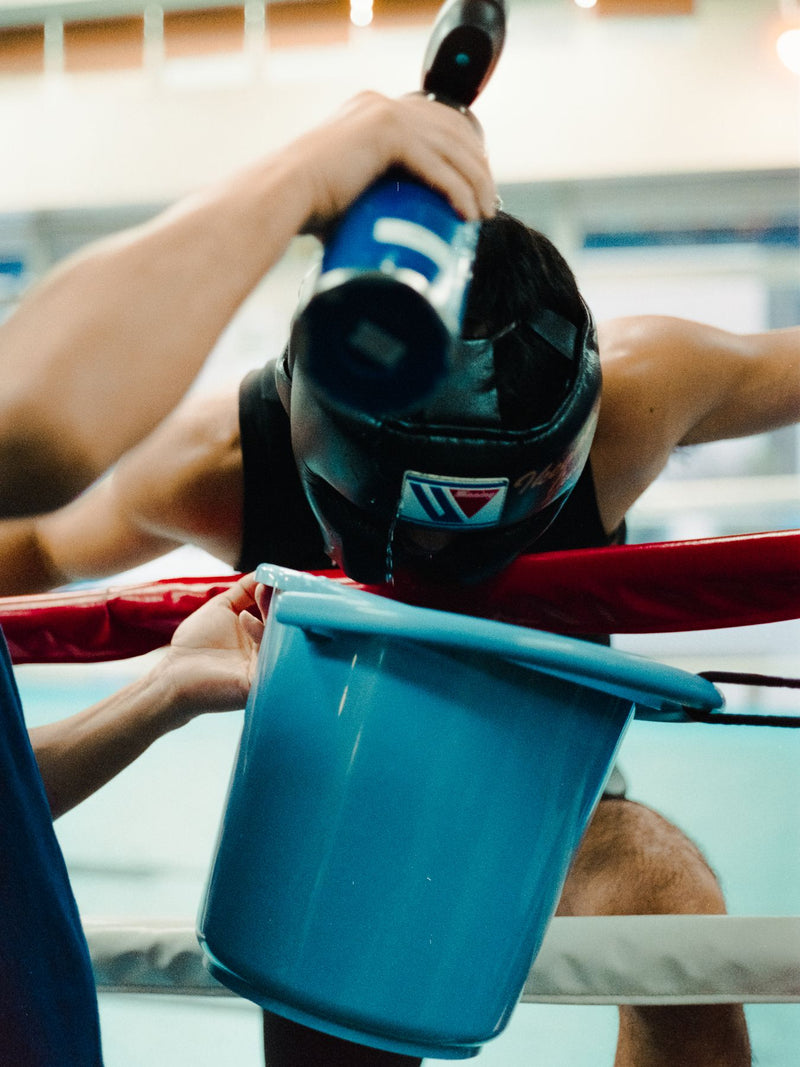 Water poured over a boxer head between rounds