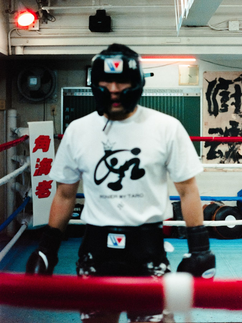 Boxer standing in the ring in headgear and gloves