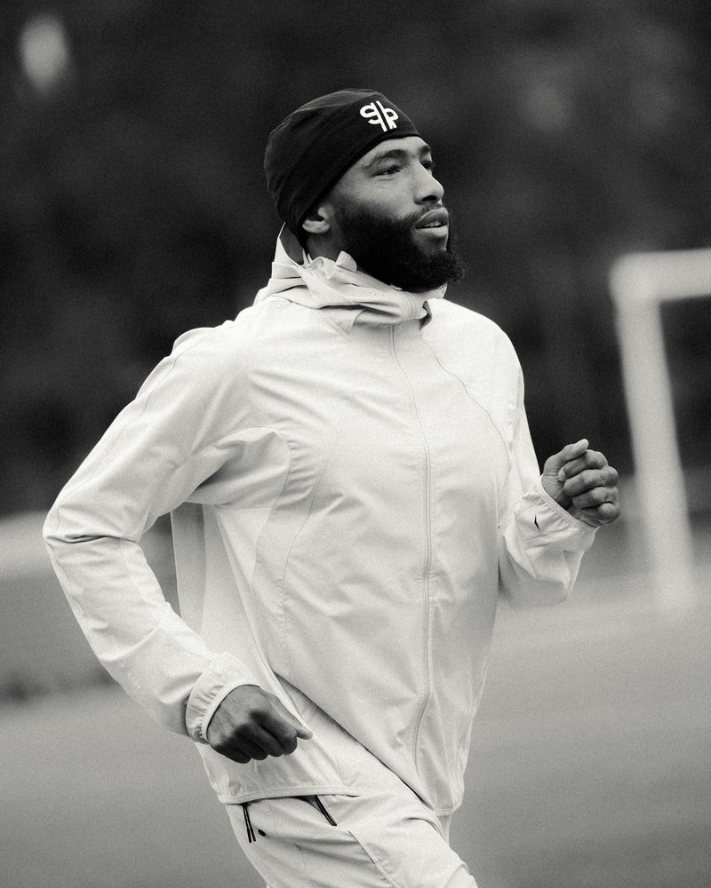 Black and white portrait of a runner in a light jacket